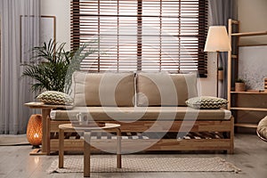 Living room interior with sofa, window blinds and decor elements