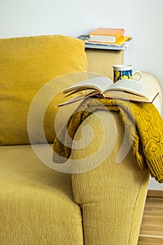 Living room interior yellow corduroy couch with cushion, knitted