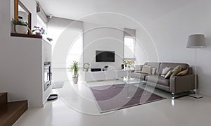 Living room with leather sofa and glass table