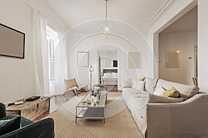 Living room with light fabric sofa, wooden doors with stained glass