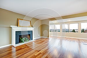 Living room in a new empty house with fireplace.