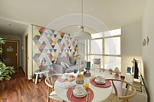 living room with round dining table with table service set with breakfast