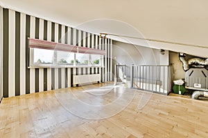 a living room with stripped walls and a wood floor