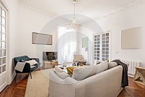 Living room with three-seater sofa upholstered in fabric with