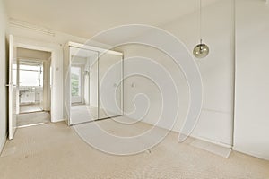 a living room with white walls and a large mirror