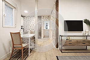 Living room with white wooden dining table, decorative paper