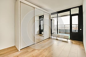 a living room with wood floors and a black door