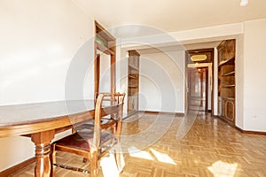 Living room with wooden bookcase and antique sofa in one corner,