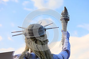 Living Statue of Liberty. USA holiday concept. Background with selective focus and copy space