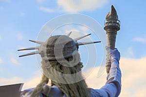 Living Statue of Liberty. USA holiday concept. Background with selective focus and copy space