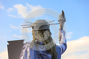 Living Statue of Liberty. USA holiday concept. Background with selective focus and copy space