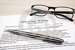 Living will declaration form with pen and glasses