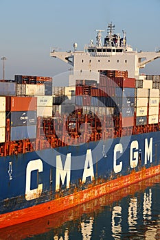 Livorno, Italy - 08 20 2023: Container terminal with stowed containers from different shippers gantry cranes and straddle carriers