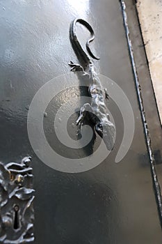Lizard-shaped door knocker on black door in Alcoy photo