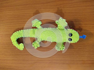 Lizard toy on wooden background