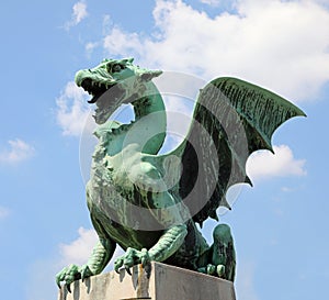 Ljubljana, L, Slovenia - August 15, 2023: dragon statue with open jaws on bridge called Zmajski most photo