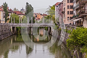 LJUBLJANA, SLOVENIA - MAY 14, 2019: Riverside buildings and the Cobblers bridge in Ljubljana, Sloven