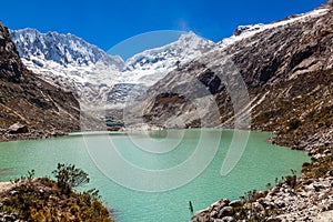 Llaca lagoon in the peruvian Andes and Ocshapalpa peak and Ranrapalca peak photo