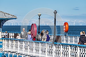 Llandudno , Wales - April 23 2018 : Folks enjoying the Pier at the seaside resort of Llandudno, North Wales, United