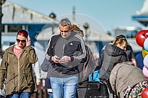 Llandudno , Wales - April 23 2018 : Folks enjoying the Pier at the seaside resort of Llandudno, North Wales, United