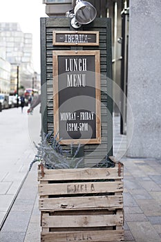 LLandudno, Wales, UK - MAY 27, 2018 Wooden black board outside the cafe. Large outdoor timings display of the resteraunt. Easle si