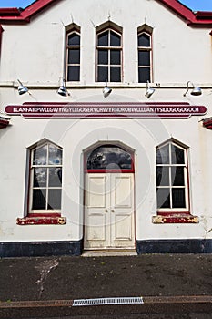 Sign on railway station building platform side for longest name Llanfairpwllgwyngyll, Anglesey, Wales photo