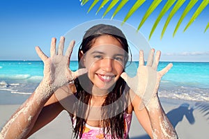 Llatin teen girl playing beach smiling sandy hands