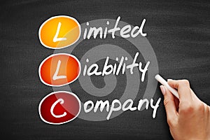 LLC - Limited Liability Company, acronym business concept on blackboard