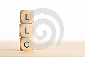 LLC or Limited Liability Company concept. Tex on wooden blocks on table