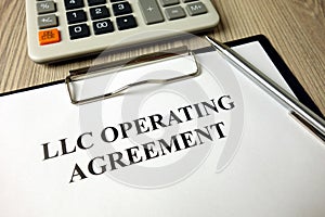 LLC operating agreement, pen and calculator on desk photo