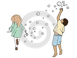 Llittle gild and boy playing with soap bubbles over white background