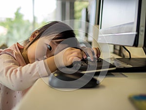 Llittle girl sitting with computer, this immage can use for education