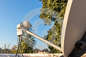 LNB, Satellite Dish over the blue sky in background photo