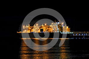 LNG tanker moored in the factory area at night.