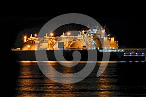 LNG tanker in port at night. Gas carrier at the GAS terminal.