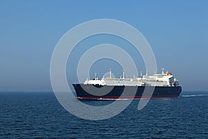 LNG tanker in transit at high seas lit by the sun
