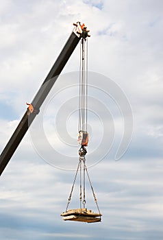 Load hanging on boom of crane