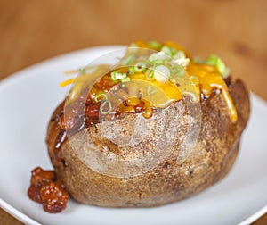 Loaded baked potato with chili and cheese photo