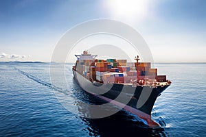 A loaded cargo container ship traveling over calm, blue sea