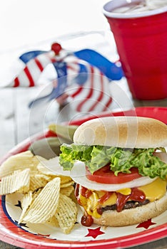 Loaded cheeseburger at a patriotic themed cookout