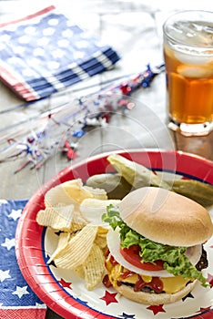 Loaded cheeseburger at a patriotic themed cookout