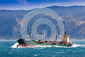 Loaded container freight ship in stormy sea