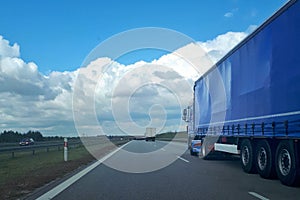 Loaded European truck transporting cargo. Truck on asphalt road. Logistic and transport