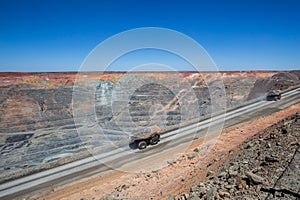 Loaded haulpaks climbing out of the Kalgoorlie Super Pit, one of the largest gold mines in the World. Gold was discovered in