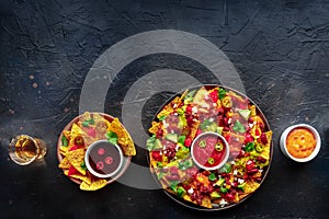 Loaded nachos. Mexican nacho chips with beef, overhead flat lay shot