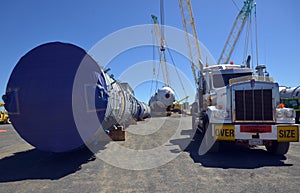 Loaded onto huge multi wheeled heavy haulage trucks are these huge refinery storage vessels.