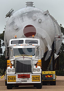Loaded onto huge multi wheeled heavy haulage trucks are these huge refinery storage vessels. photo