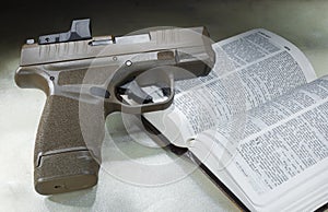 Loaded pistol on an open bible