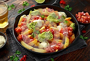 Loaded potato nachos with melted cheddar cheese, sour cream, tomato salsa, chilli, guacamole and beer