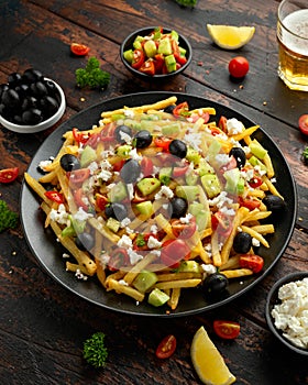 Loaded potato Vegan Fries with tomato, cucumber, olives and feta cheese